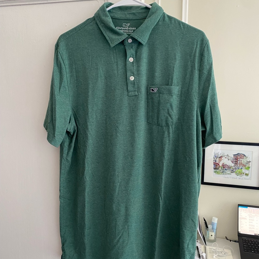 Green performance polo from Vineyard Vines with three buttons and chest pocket.